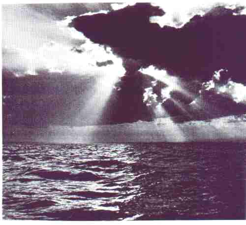 Picture of the sea with sun rays streaming on it.